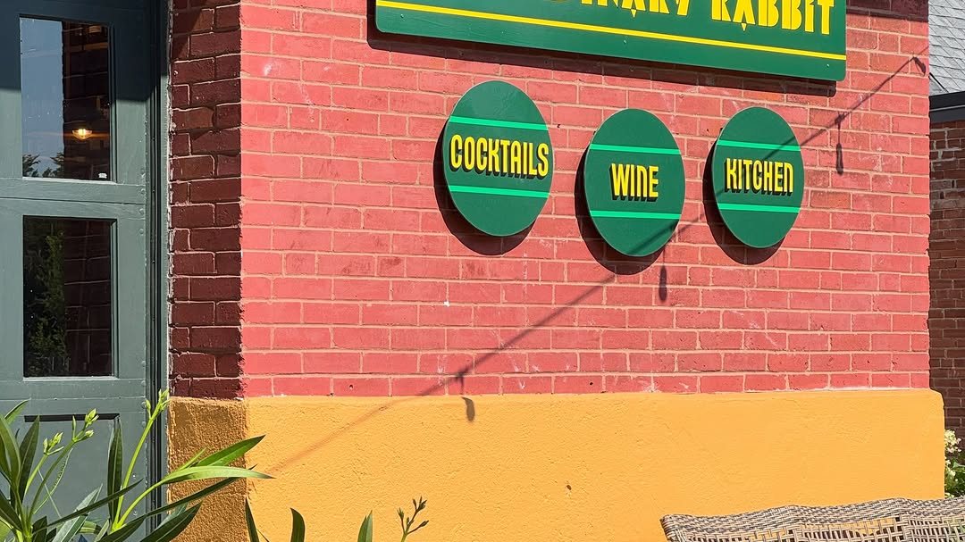 Cocktails, Wine and Kitchen signs on the red brick wall at No Ordinary Rabbit